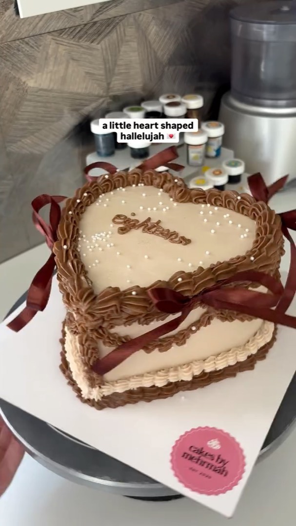 Chocolate heart cake with dark red ribbons