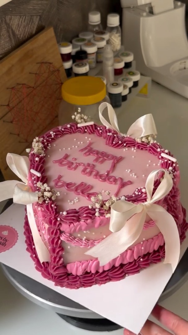 Pink ruffled birthday cake with bows
