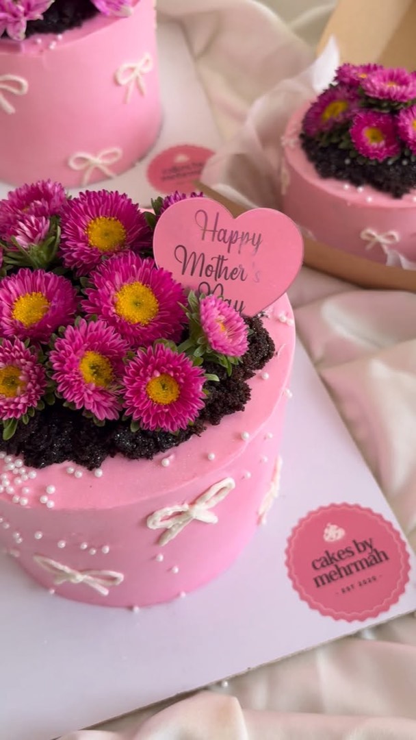 Pink Mother's Day cake with fresh flowers