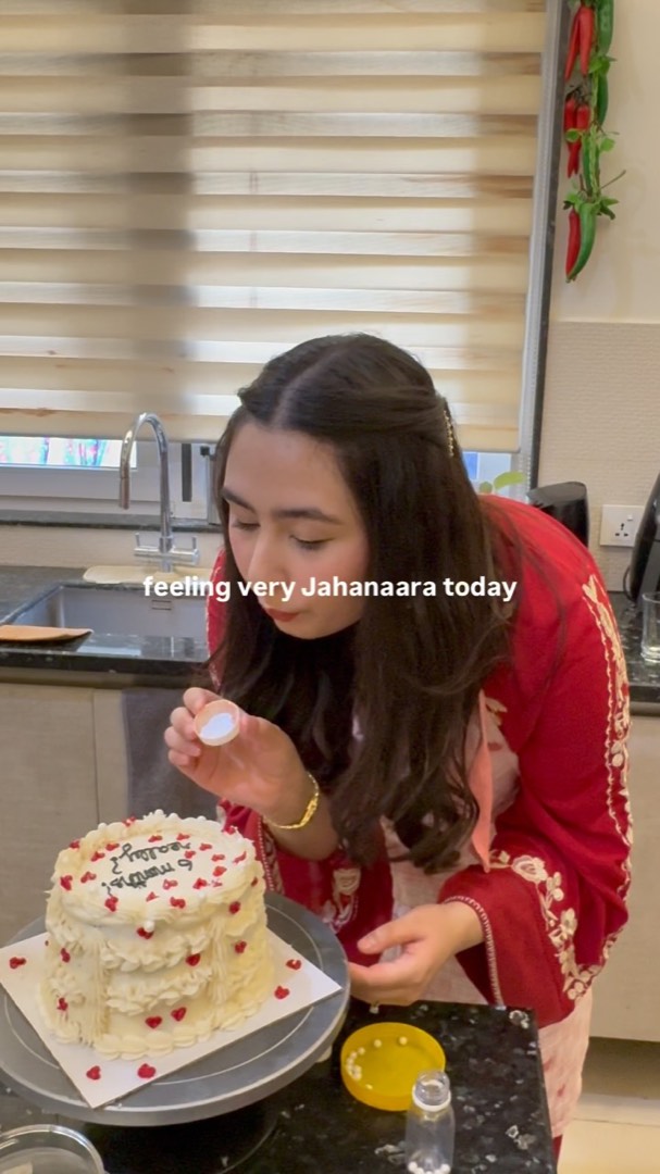 Mehrmah Ali blowing out a candle on one of her cakes
